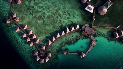 An offshore village in a stunning top-down view, filmed by drone above crystal Stock Footage 239927699