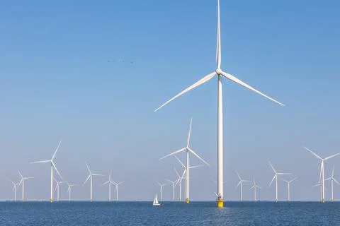 Offshore wind farm with many windmills, the Netherlands with sailboat Stock Photos