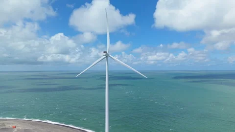 Offshore wind turbine spinning at the Eastern Scheldt barrier generating 動画素材 338127439