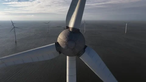 Offshore wind turbine spinning producing clean energy Stock Footage 327331188