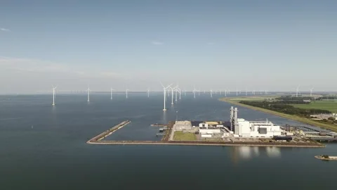 Offshore windfarm and a Gas fired powerstation on dutch shores Stock Footage 289964576