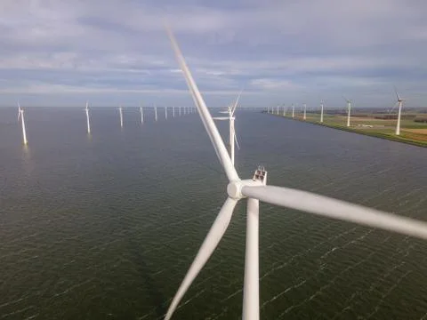 Offshore windmill park with clouds and a blue sky, windmill park in the ocean Stock Photos
