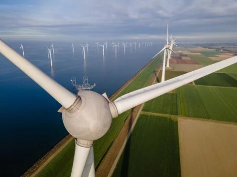 Offshore windmill park with clouds and a blue sky, windmill park in the ocean Stock Photos