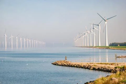 Offshore windmill park with clouds and a blue sky, windmill park in the ocean Stock Photos