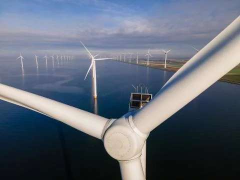 Offshore windmill park with clouds and a blue sky, windmill park in the ocean Stock Photos