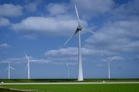 Offshore windmill park with clouds and a blue sky, windmill park in the ocean Stock Photos