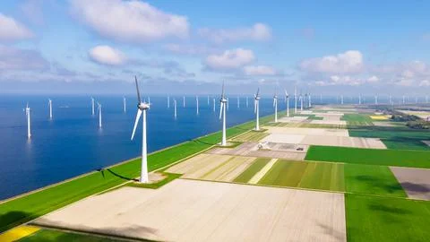 Offshore windmill park with clouds and a blue sky Stock Photos