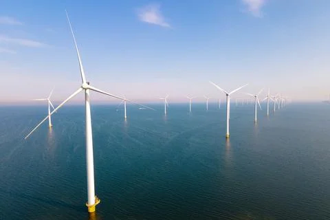 Offshore windmill park with clouds and a blue sky Stock Photos
