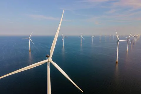Offshore windmill park with clouds and a blue sky Stock Photos