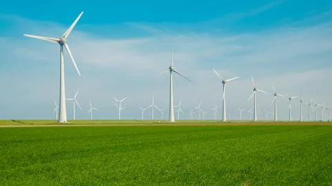 Offshore windmill park with clouds and a blue sky, wind mill turbines in the Stock Photos
