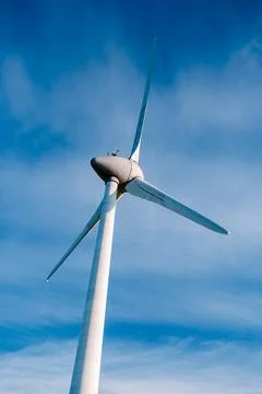 Offshore windmill park with stormy clouds and a blue sky, windmill park in the Stock Photos