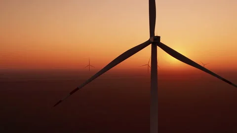 Offshore windmills rotate against sunset producing energy Stock Footage 166355649