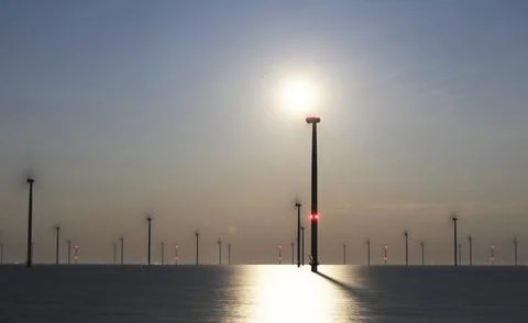 An offshore windpark at night Stock Photos