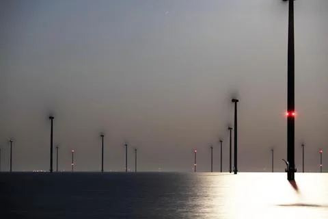 An offshore windpark at night Stock Photos