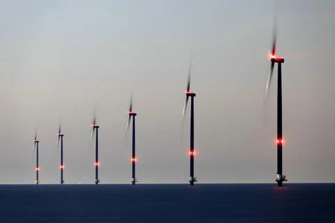 An offshore windpark at night Stock Photos