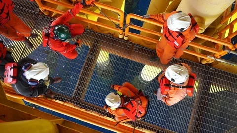 Offshore workers changing new galvanised grating at well head platform. Stock Footage 94557318