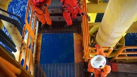 Offshore workers changing new galvanised grating at well head platform. Stock Footage 94558138