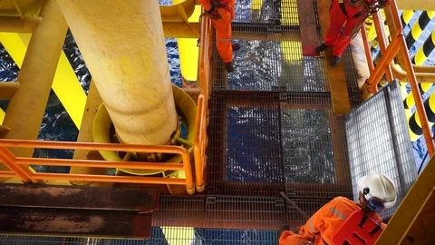 Offshore workers changing new galvanised grating at well head platform. Stock Footage 94558420