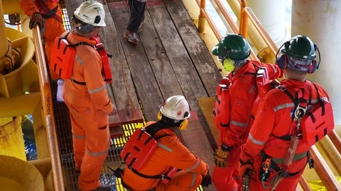 Offshore workers changing new galvanised grating at well head platform. Stock Footage 94558790