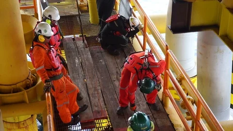 Offshore workers changing new galvanised grating at well head platform. Stock Footage 94558796