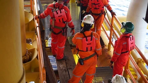 Offshore workers changing new galvanised grating at well head platform. Stock Footage 94559128