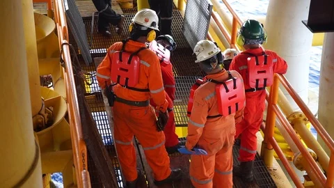 Offshore workers changing new galvanised grating at well head platform. Stock Footage 94559265