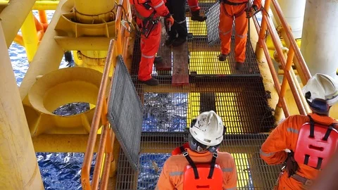 Offshore workers changing new galvanised grating at well head platform. Video stock 94559376