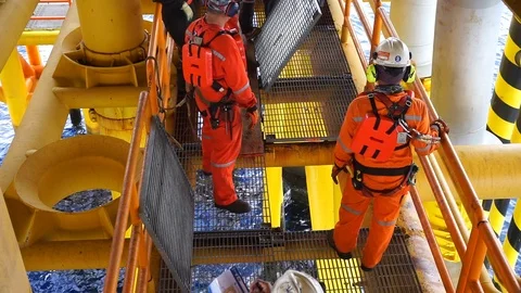 Offshore workers changing new galvanised grating at well head platform. Video stock 94559586