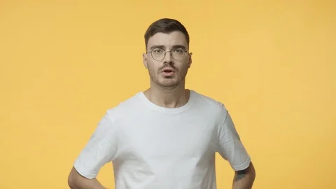Oh gosh what is this. Scared young speechless guy in glasses, react alarmed and Video stock 121515077