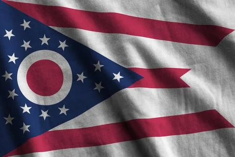 Ohio US state flag with big folds waving close up under the studio light indoors Photos