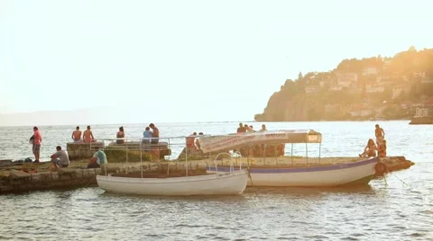 OHRID, MACEDONIA, JUNE 2015: People chilling at Ohrid lake at sunset. Stock Footage 59776784