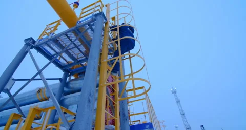 Oil and gas complex worker climbs the stairs to the control platform Stock Footage 105988264