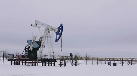 Oil and gas industry. Work of oil pump jack on a oil field. Stock Footage 65415782