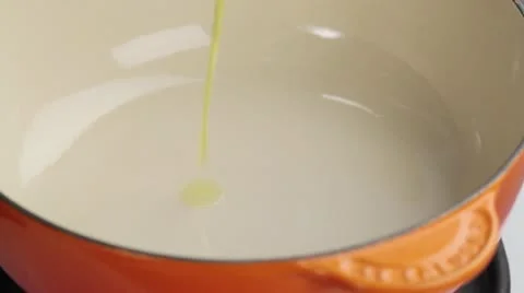 Oil being added to a saucepan Stock Footage 24656828