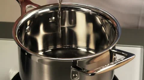 Oil being poured into a large pot Stock Footage 24671937