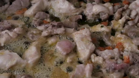 Oil boiling in a pot full of meat and vegetables. Stock Footage