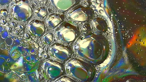 Oil bubbles on glass background Stock Footage 202203571