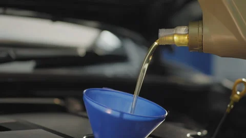 Oil change close up pour engine oil 50fps Video stock 246380579