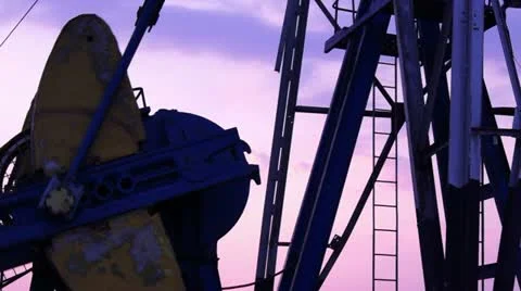 Oil Derrick mechanism in the sunset Stock Footage