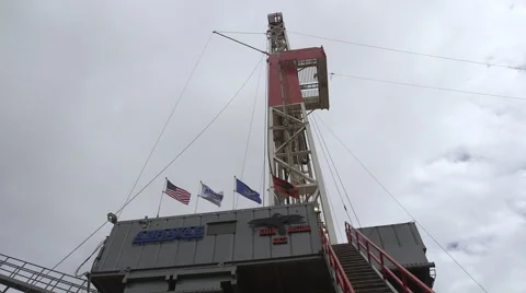 Oil Drill and Waving Flags Stock Footage 44474733