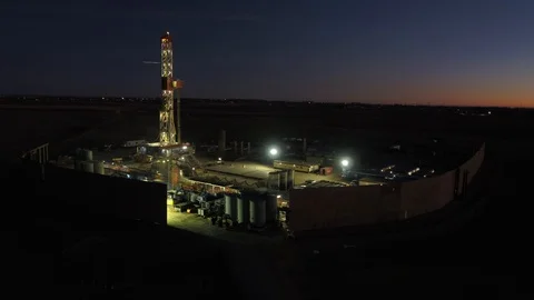 Oil drill rig pre-sunrise - drone aerial Stock Footage