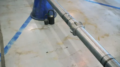 Oil drilling pipe positioned for maintenance in workshop Stock Footage 309328211