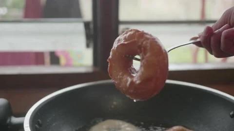 Oil dripping from doughnut Stock Footage 60688991