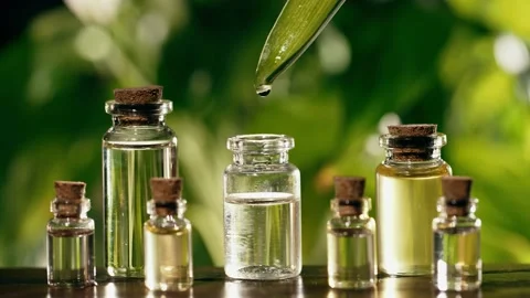 Oil dripping from a leaf into a bottle 스톡 동영상 172638647