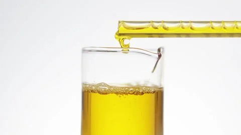 Oil drips from pipette into bottle.  Stock Footage 242748285