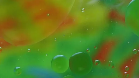 Oil-drops floating in water Stock Footage