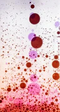 Oil drops on water surface Stock Photos