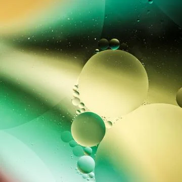 Oil drops on water surface Stock Photos