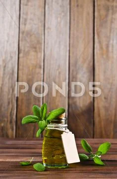 Oil with dry leaves of sage Stock Photos