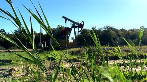 Oil extraction machinery on dramatic silhouette sunset. Stock Footage 344267158